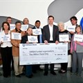 Thomas Schaefer, chairman and MD, VW Group SA with representatives of the 11 local charities that received the R2m donation.