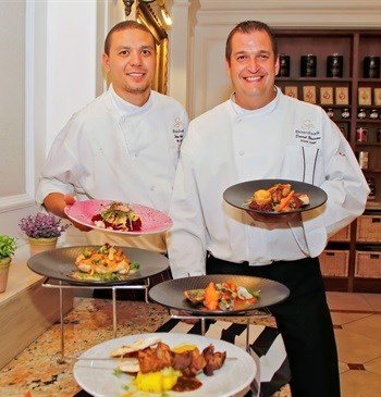Left to right: Sous Chefs Sergio Adams and Darrel Brussow of the Boardwalk showcasing some of the scrumptious meals available on the new summer menu
