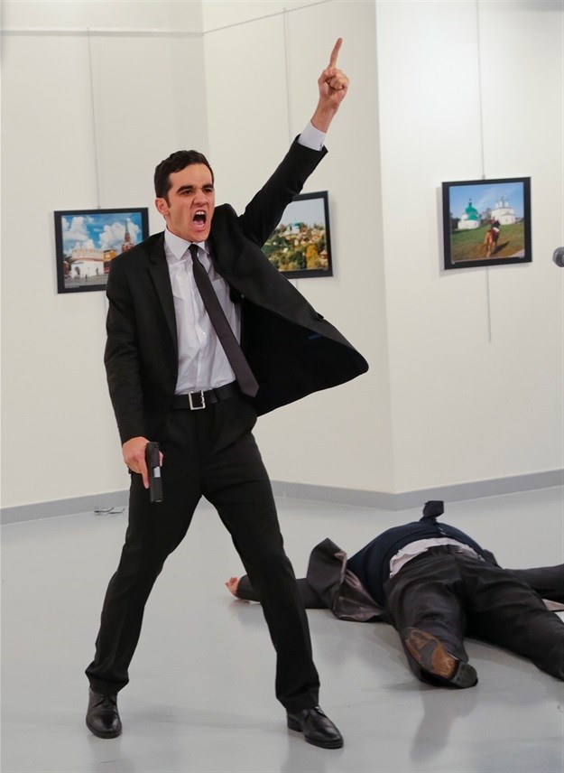 Mevlut Mert Altintas shouts after shooting Andrei Karlov, the Russian ambassador to Turkey, at an art gallery in Ankara, Turkey on 19 December 2016. Picture: Burhan Ozbilici,