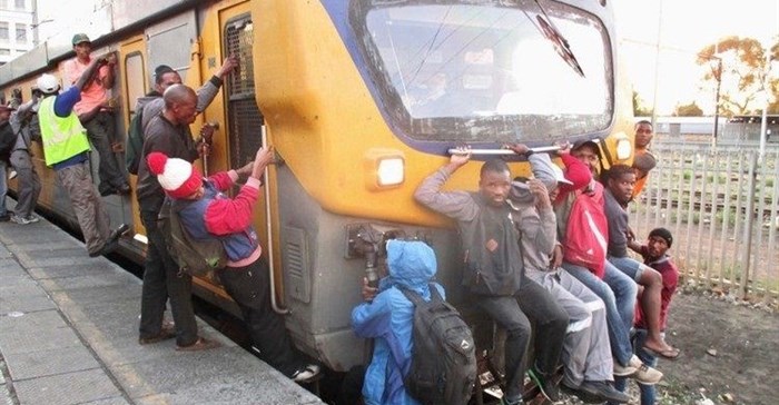 Commuters climbing on a Khayelitsha-bound train. Photo: Mandla Mnyakama
