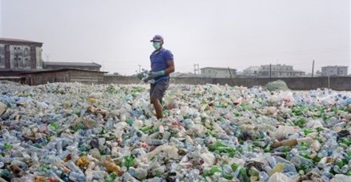 A man sorting a sea of plastic bottles at one of the Wecycler hubs in Lagos, Nigeria. Most plastic litter from cities ends up in oceans. Photo: Panos/Joan Bardeletti