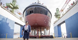 Lady Sponsor of the Usiba tug, Judith Nzimande, with the new tug which will serve at the Port of Richards Bay.