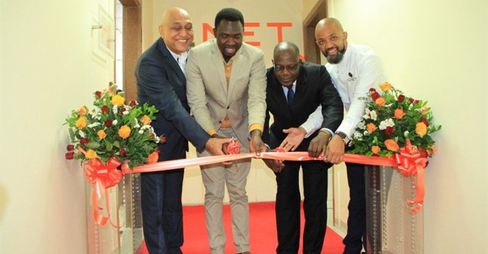 QNET Board Adviser, David Sharma; Deputy Minister for Health, Community Development, Children and Elderly, Hamisi Kigwangalla; Permanent Secretary for Trade, Industry and Investment Adelhelm Meru and QNet Country Representative for Tanzania Benjamin Mariki cut the ribbon during the opening of QNet agent office in Tanzania.
