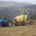 A baling machine collects loose grass and turns it into bales on a farm in Mid-Illovo to be transported to farmers in need in the Eastern Cape