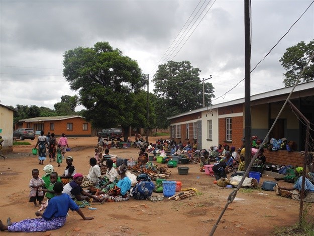Patients outside a healthcare facility in Malawi where solar panels were installed.