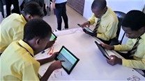 Learners using their newly acquired tablets