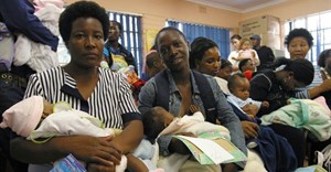 Mothers wait at a local clinic. The city of Johannesburg plans to open 24 hour clinics to alleviate queues. Photo: Reuters stringer