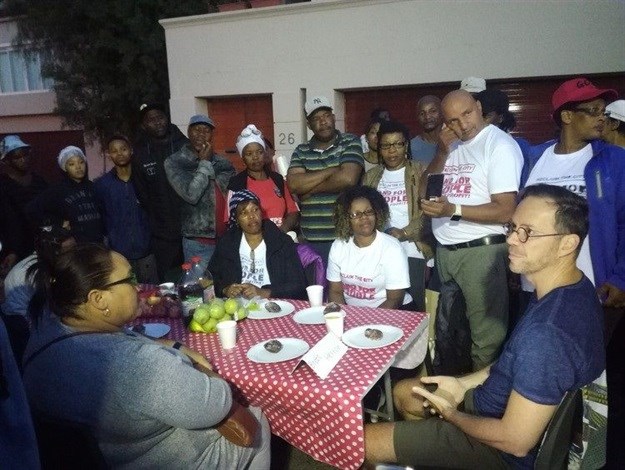 Cape Town Mayco Member Brett Herron discussing emergency housing with picketers outside his home in Newlands early on Tuesday morning. Photo: Barbara Maregele