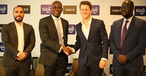 Tigo managing director, Simon Karikari, (second left), and the general manager of Uber East Africa, Loic Amado, shake hands after announcing the partnership between Tigo and Uber Tanzania in Dar es Salaam. Others are: Uber country manager, Alfred Msemo and Tigo’s head of mobile financial services, Hussein Sayed. Source: Tigo.