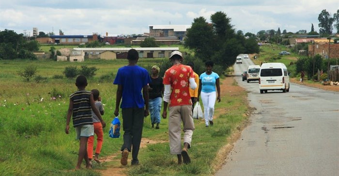 People stroll along Moshoeshoe Street in Emfuleni. Darya Maslova