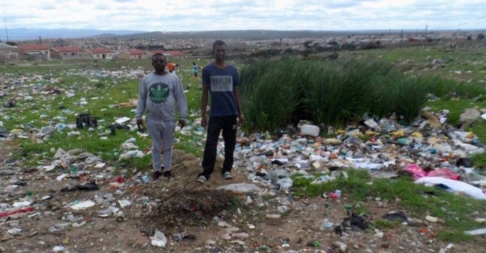 Damion Daniels (left) and Andrew Muller show the extent of illegal dumping in Jacksonville. Photo: Joseph Chirume