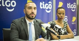 Tigo Tanzania's chief officer for mobile financial services, Hussein Sayed (left), briefs journalists on the GSMA Mobile Money Certification. Flanking him is Tigo's corporate communications manager, Woinde Shisael (right).