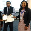 Peaceful Mathebula (left) and Tomi Oshokoya (right) receive certificates for their presentation from Professor DK Banwet (middle) in Thailand