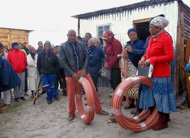 Residents of Siyahlala informal settlement in Khayelitsha prepare to install their own water taps. Photos: Vincent Lali