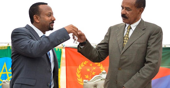 Ethiopian Prime Minister Abiy Ahmed, left, and Eritrean President Isaias Afwerki celebrate the reopening of the Embassy of Eritrea in Addis Ababa on July 16. An Ethiopian news crew was attacked and their driver killed while traveling to the capital to cover the visit. Credit: AFP/Michael Tewelde.