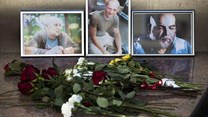 Flowers and photos of Aleksandr Rastorguyev, Kirill Radchenko, and Orkhan Dzhemal, are left at the journalist union building in Moscow. The Russian journalists were killed while on assignment in the Central African Republic. Credit: AP/Pavel Golovkin/CPJ.