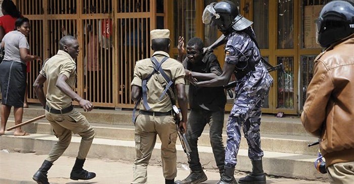Security forces detain a protester in Kampala on August 20. Security personnel beat and detained at least four journalists who were covering unrest in Uganda's capital. Credit: AP/Ronald Kabuubi/CPJ.