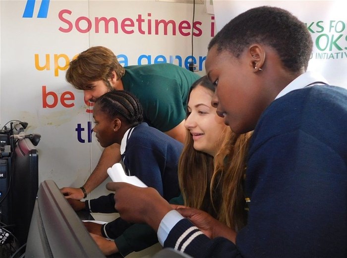 Springbok, Lood De Jager and Women’s Sevens Rugby player, Chané Stadler learning to code with students from Emdeni Secondary School in Soweto.