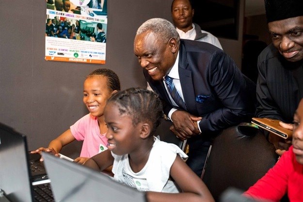 South African Minister of Telecommunications & Postal Services, Hon. Dr Siyabonga Cwele showcasing the importance of computer code to sisters, Nosipho and Karabo Mayisa, at the opening of Africa Code Week.
