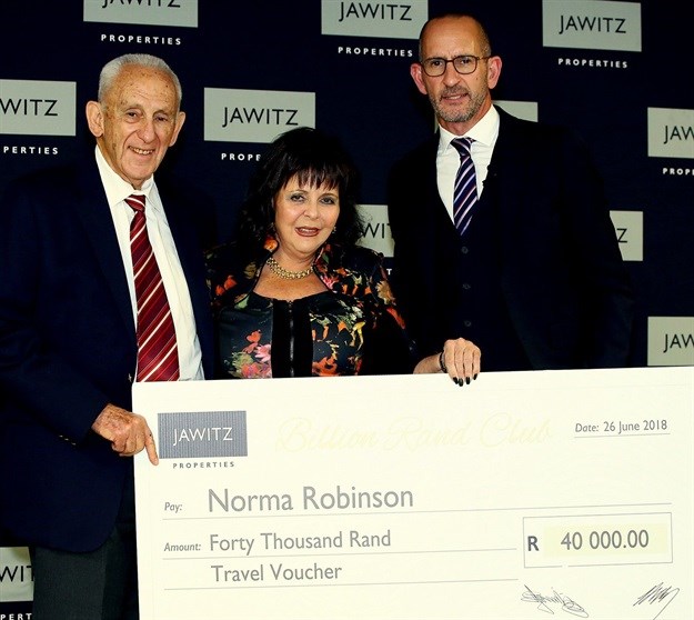 Norma Robinson receiving her gift cheque in recognition of joining the Jawitz Billion Rand Club