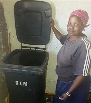 Asakhe Dontwana fills a black municipal rubbish bin with water when the village taps are working. Photo: Nombulelo Damba-Hendrik