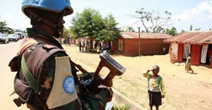 A Congolese child saluting a MONUSCO peacekeeper. Abel Kavanagh/Wikimedia Commons, CC BY-SA