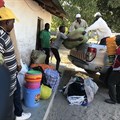 Internally displaced people offload food, blankets, and other goods after fleeing militant attacks in Naunde, northern Mozambique, on June 13, 2018. A Mozambican journalist was arrested on January 5, 2019, and held in a military prison after photographing families who fled the militant attacks. Credit: CPJ/AFP/Joaquim Nhamirre.