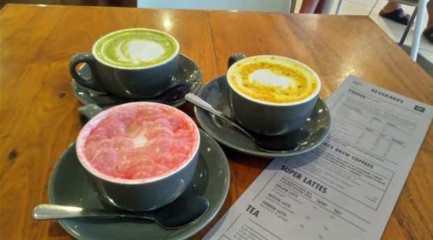 A turmeric, beetroot and matcha latte at Woolworths Cafe. Credit: Superlatte