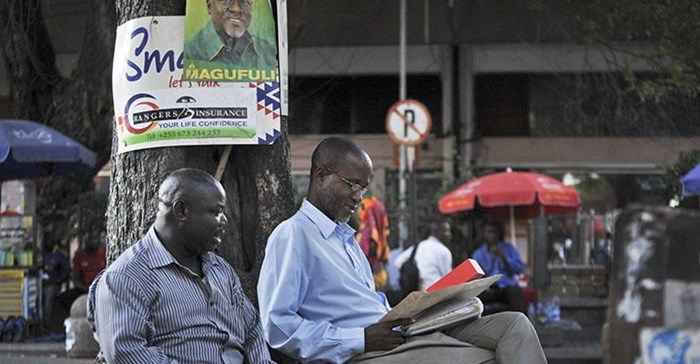 Tanzanians sit next to a tree in Dar es Salaam in 2015. Tanzanian authorities this week imposed a temporary ban on The Citizen over its reporting. Credit: CPJ/AP/Khalfan Said.