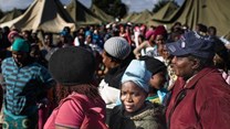 People queue in makeshift camps following past threats of xenophobic attacks in South Africa. Today, rescinded health department memos requesting foreigners pay in full for healthcare have sparked a national debate. (Fredrik Lemeryd)