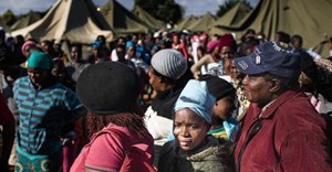 People queue in makeshift camps following past threats of xenophobic attacks in South Africa. Today, rescinded health department memos requesting foreigners pay in full for healthcare have sparked a national debate. (Fredrik Lemeryd)