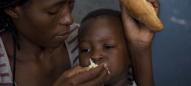 A mother feeds her two-year-old son at the Samora Machel school where they were brought after their homes were destroyed and flooded in Buzi, Mozambique (Image: UNICEF / Prinsloo)