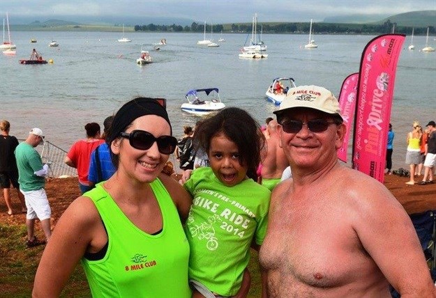 Taking the 8 Mile Club into wilder waters, Stanley Kozlowski and seven other adventure swimmers hope to raise R250,000 for eco-tourism, marine conservation and environmental journalism training by swimming a 22km stretch of the Wild Coast earmarked for heavy minerals mining. He is pictured here, at the finish line of the Midmar Mile, with his daughter Nastassja Kozlowski and granddaughter Gabriella. Photo supplied