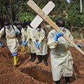 Health workers burying a child who died of Ebola in the DRC’s North Kivu province. Hugh Kinsella Cunningham/EPA