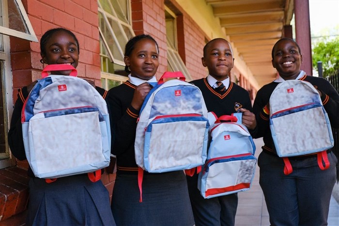 Students at the Emfundisweni Primary School in Alexandra with their upcycled Emirates school bags