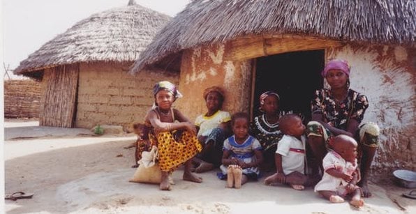 A mother and her children outside their home in rural Nigeria. Shobana Shankar, CC BY-SA