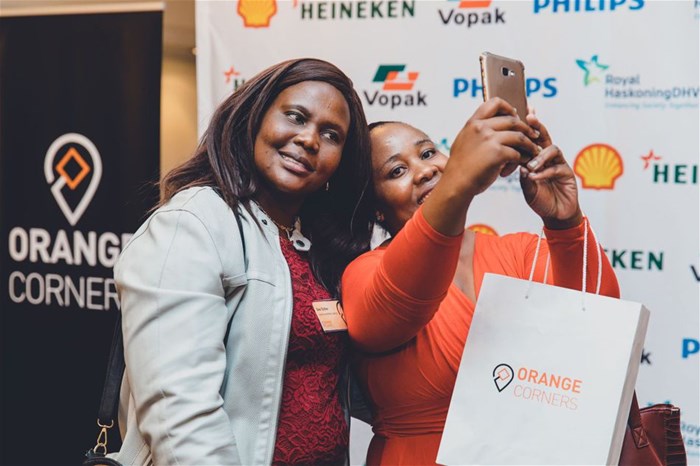 Excited 2019 Orange Corners entrepreneurs taking selfies at the launch event.