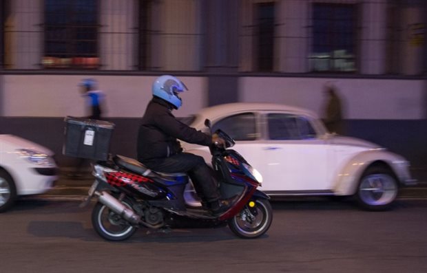 A scooter delivery driver heads down Main Road, Observatory, at night. At least six drivers have died on the job in Cape Town since 2017, and many more have been injured. A spokesperson for NetCare 911’s ambulance service, Shawn Herbst, said that accidents involving food couriers had “exploded” across South African cities in the past 18 months.