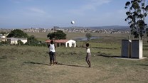 Young girls play netball in an open field near King Williams Town. EPA/Kim Ludbrook