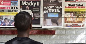 A man looks at newspaper front pages in Dakar, on February 25, 2019, one day after Senegal's presidential elections. Senegalese authorities arrested critical journalist Adama Gaye on July 29. Credit: CPJ/AFP/Seyllou.