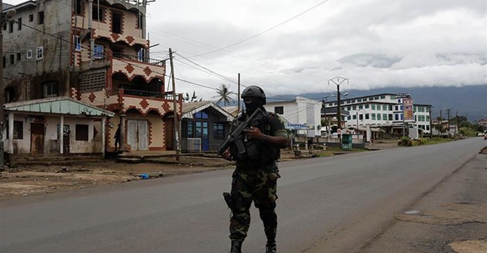 A Cameroonian elite Rapid Intervention Battalion member walks along an empty street in the city of Buea in Cameroon's Anglophone southwest region on October 4, 2018. Cameroon’s military detained pidgin news anchor Samuel Wazizi on August 2, 2019, in Buea. Credit: CPJ/Reuters/Zohra Bensemra.