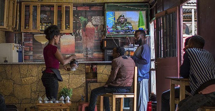 PIC: Ethiopians follow the news on television at a cafe in Addis Ababa, Ethiopia Sunday, June 23, 2019. Ethiopian authorities arrested journalist Mesganaw Getachew on August 9 after he filmed outside a court in Addis Ababa. Credit: CPJ/AP Photo/Mulugeta Ayene.
