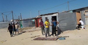 Residents from Mpukwini informal settlement in Khayelitsha have begun rebuilding homes demolished by the anti-land invasion unit two weeks ago. The residents plan to oppose their eviction in court next month. Photo: Vincent Lali