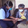 A community care worker providing treatment to a TB patient at her home. Wikkicommons/Stherere23
