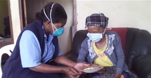 A community care worker providing treatment to a TB patient at her home. Wikkicommons/Stherere23