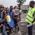 A health worker spreading disinfectant at a health checkpoint in Goma, DRC. Patricia Martinez/EPA-EFE