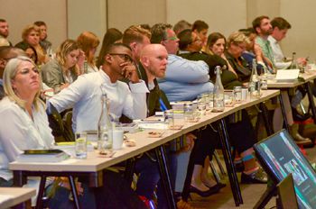 Speakers and conference delegates listening intently