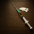 Syringe and cooked heroin. TM_SALE/Shutterstock
