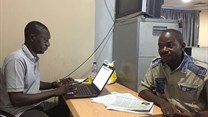 Hamza Idris (left), an editor with the Daily Trust newspaper, sits with colleague Hussaini Garba Mohammed in their office in the Nigerian capital, Abuja, in February 2019. The office was raided in January by the military, who seized 24 computers. Credit: CPJ/Jonathan Rozen.