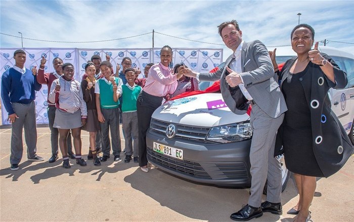 Thomas Schaefer (second from right), Volkswagen Group South Africa Chairman and Managing Director, and Nonkqubela Maliza (far right), VWSA's Director of Corporate and Government Affairs, hand over the keys of a new Volkswagen Caddy to Dr Linda Nkomo (left), CEO of loveLife, and beneficiaries of the loveLife Youth Centre in KwaNobuhle.